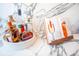 A stylish white tray with various liquor bottles and a cocktail recipe book is situated on a marble countertop at 3688 Goodwater St, Mount Pleasant, SC 29466