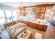 Expansive living room with custom bar featuring marble backsplash, wooden cabinets, and gold accents at 3688 Goodwater St, Mount Pleasant, SC 29466