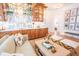 Bright living room with a custom bar featuring wooden cabinets, marble backsplash, and gold accents at 3688 Goodwater St, Mount Pleasant, SC 29466