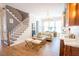 Bright living room features hardwood floors, stairs, a gold chandelier, and a wet bar with white marble countertops at 3688 Goodwater St, Mount Pleasant, SC 29466