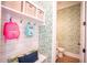 Mudroom and half bath with leafy green wallpaper and white accents at 3688 Goodwater St, Mount Pleasant, SC 29466