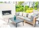 Inviting outdoor seating area with a fireplace, comfortable sofa, and stylish decor at 3688 Goodwater St, Mount Pleasant, SC 29466