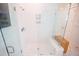 Modern glass enclosed shower with built in storage and white subway tile at 3688 Goodwater St, Mount Pleasant, SC 29466