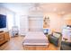 Sofa bed down, showing hardwood floors, a mini fridge, shelving and cabinets, and overhead ceiling fan at 3688 Goodwater St, Mount Pleasant, SC 29466