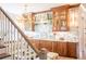 A luxurious wet bar and chandelier connect to the living room via the staircase at 3688 Goodwater St, Mount Pleasant, SC 29466