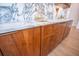 Marble counter with gold fixtures, sink, and wood cabinetry creates a luxurious wet bar at 3688 Goodwater St, Mount Pleasant, SC 29466