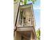Beautiful balcony with white railing, decorative chairs, and exterior pendant light fixture at 4 Catfiddle St, Charleston, SC 29403