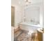 Inviting bathroom with soaking tub, stylish rug, and elegant lighting fixture at 4 Catfiddle St, Charleston, SC 29403