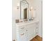 Stylish bathroom vanity featuring a framed mirror, elegant lighting, and ample storage with drawers and cabinets at 4 Catfiddle St, Charleston, SC 29403