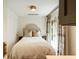 Cozy bedroom featuring a comfortable bed, soft lighting, and an inviting atmosphere, with french doors leading to the outside at 4 Catfiddle St, Charleston, SC 29403