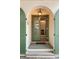 Inviting entryway featuring a green door and shutter with a lantern offering a glimpse of the well-lit interior at 4 Catfiddle St, Charleston, SC 29403