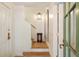 Bright entryway with hardwood floors, a staircase, and a stylish light fixture, exuding warmth and elegance at 4 Catfiddle St, Charleston, SC 29403