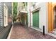 Charming home with balcony and traditional green shutters along brick paved street at 4 Catfiddle St, Charleston, SC 29403
