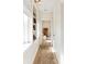 Bright hallway with rug, features a built-in bookshelf and leads to a bedroom at 4 Catfiddle St, Charleston, SC 29403