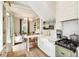 Bright open kitchen concept with a dining area, white cabinetry, farmhouse sink, and gas range at 4 Catfiddle St, Charleston, SC 29403