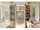 Inviting living room with built-in bookshelves, french doors to the porch, and a cozy sofa at 4 Catfiddle St, Charleston, SC 29403
