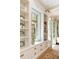 Bright dining area featuring built-in cabinets, shelves, a window seat, and french doors at 4 Catfiddle St, Charleston, SC 29403