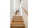 Bright staircase with wood treads and white risers leads to the upper level at 4 Catfiddle St, Charleston, SC 29403
