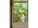 Close up of a window showing a beautiful tree view, bringing the outdoors in at 4 Catfiddle St, Charleston, SC 29403