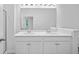 Bright bathroom featuring a double sink vanity with white cabinets, quartz countertop, and a large mirror at 403 Cadbury Loop, Summerville, SC 29486