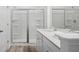 Bathroom featuring a glass-enclosed shower and double sink vanity with white cabinets and quartz countertop at 403 Cadbury Loop, Summerville, SC 29486