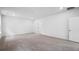 Large carpeted room with white walls, a door and bright natural light from a single window at 403 Cadbury Loop, Summerville, SC 29486