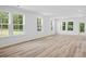 Bright, open living room with large windows and vinyl plank flooring, perfect for entertaining at 403 Cadbury Loop, Summerville, SC 29486