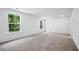 Spacious living room features carpeting and multiple windows, offering abundant natural light at 403 Cadbury Loop, Summerville, SC 29486