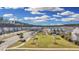 Beautiful aerial view of community park, homes, and landscaping with pond at 404 Snowy Plover Ln, Summerville, SC 29486