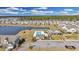 Aerial view of a neighborhood, featuring a community pool and surrounding homes with lake view at 404 Snowy Plover Ln, Summerville, SC 29486