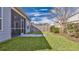 Backyard featuring screened in porch and manicured lawn and tall privacy fence at 404 Snowy Plover Ln, Summerville, SC 29486