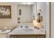 Powder room featuring a white countertop vanity, modern fixtures, and decorative elements at 404 Snowy Plover Ln, Summerville, SC 29486