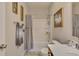 Cozy bathroom features a tub and shower combo, a light-colored vanity, and decorative accents at 404 Snowy Plover Ln, Summerville, SC 29486