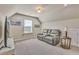 Cozy bonus room featuring a plush reclining sofa and a television, perfect for relaxation and entertainment at 404 Snowy Plover Ln, Summerville, SC 29486