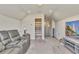 Relaxing bonus room featuring plush seating, a wall-mounted television, and natural light at 404 Snowy Plover Ln, Summerville, SC 29486