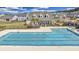 Community pool with an outdoor seating area and beautifully landscaped surroundings at 404 Snowy Plover Ln, Summerville, SC 29486