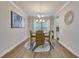 Elegant dining room features a round table, hardwood floors, stylish lighting, and neutral color palette at 404 Snowy Plover Ln, Summerville, SC 29486