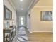 Inviting entryway features hardwood floors, stylish console table, decorative mirror, and a patterned rug at 404 Snowy Plover Ln, Summerville, SC 29486