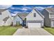 Charming exterior elevation of two story home with driveway and landscaping at 404 Snowy Plover Ln, Summerville, SC 29486