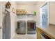 Well-organized laundry room equipped with modern washer and dryer, shelving, and ample countertop space at 404 Snowy Plover Ln, Summerville, SC 29486