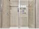 Tiled shower with glass door and built in shelves to hold soap and shampoo at 404 Snowy Plover Ln, Summerville, SC 29486