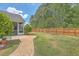 Beautifully landscaped backyard with brick pathway, screened in porch and wood fence at 405 Decatur Dr, Summerville, SC 29486