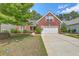 Traditional brick home featuring a well-manicured lawn and a two-car garage at 405 Decatur Dr, Summerville, SC 29486