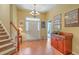 Bright foyer with hardwood floors, staircase, chandelier, and elegant decor at 405 Decatur Dr, Summerville, SC 29486