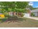 Charming brick home featuring a well-manicured lawn and mature tree in a suburban neighborhood at 405 Decatur Dr, Summerville, SC 29486