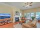Cozy living room with a fireplace, ceiling fan, and ample natural light at 405 Decatur Dr, Summerville, SC 29486