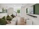 Cozy basement living area with a plush sofa, large television, and open staircase to upstairs at 406 Cadbury Loop, Summerville, SC 29486