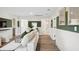 Basement hallway and living area with a stylish white sofa, and doorways to a bathroom and bedroom at 406 Cadbury Loop, Summerville, SC 29486