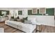 Basement living area with a large white sofa, decorative pillows, and modern side table at 406 Cadbury Loop, Summerville, SC 29486