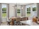 Dining room with modern light fixture and bright natural light coming in from the windows at 406 Cadbury Loop, Summerville, SC 29486